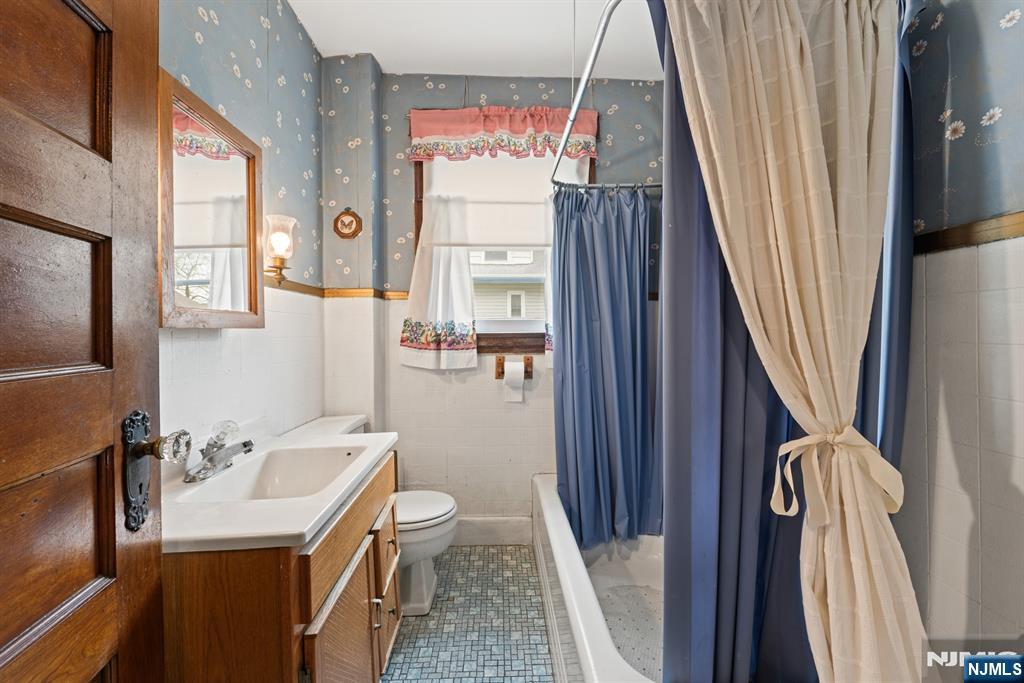 10 Beech Street Rutherford, NJ 07070 - Photo 21 of 41 a bathroom with a sink a toilet and a mirror