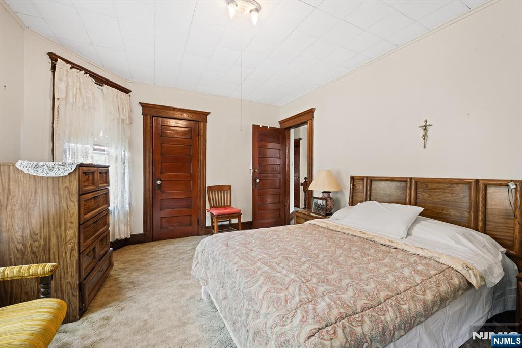 10 Beech Street Rutherford, NJ 07070 - Photo 30 of 41 a bed sitting in a spacious bedroom next to a window