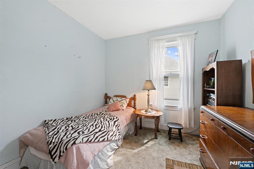 10 Beech Street Rutherford, NJ 07070 - Photo 32 of 41 a bedroom with a bed and a flat tv screen on dresser
