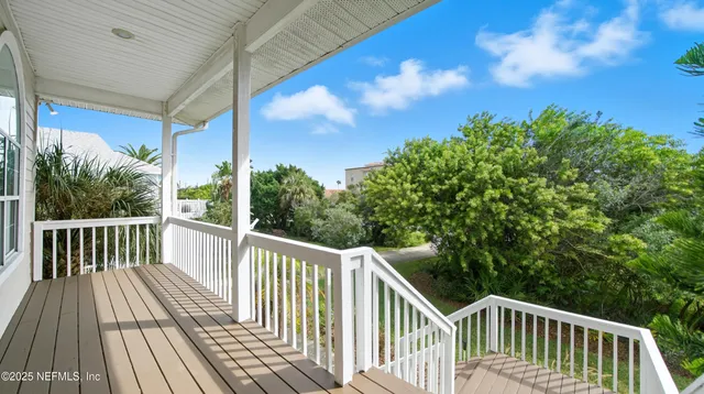 a view of a balcony with wooden floor