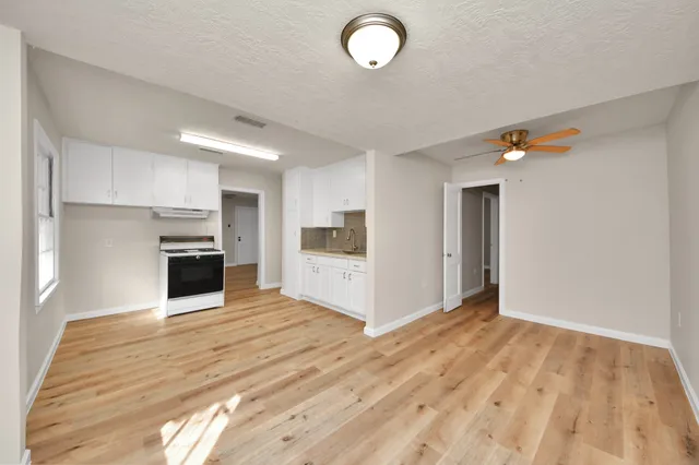 a view of a kitchen with microwave and cabinets