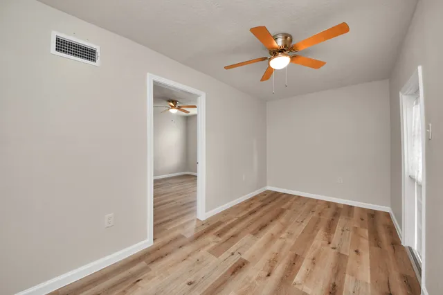 wooden floor in an empty room with a window