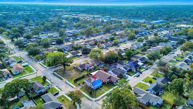 an aerial view of residential houses with outdoor space and street view