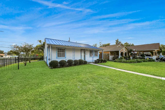 a front view of house with a garden
