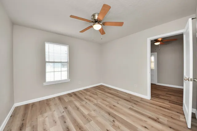 wooden floor in an empty room with a window