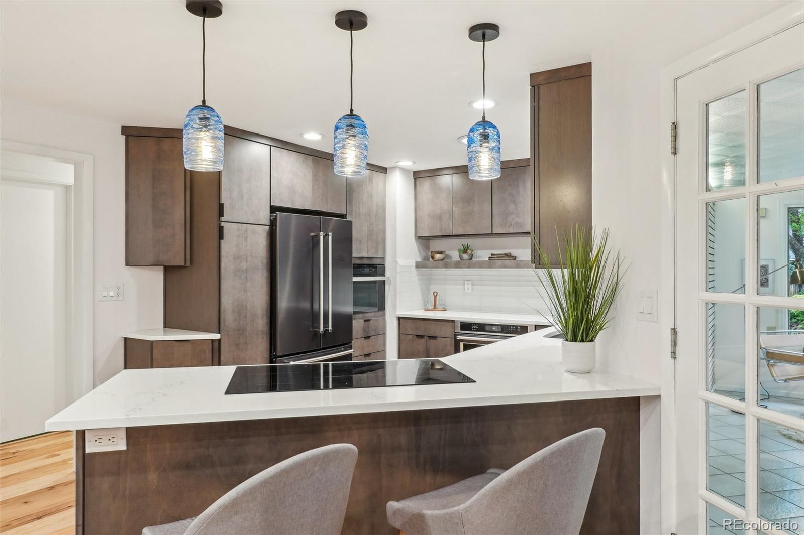 1118 Eagle Road Broomfield, CO 80020 - Photo 11 of 50 a kitchen with stainless steel appliances kitchen island granite countertop a refrigerator a stove and a sink