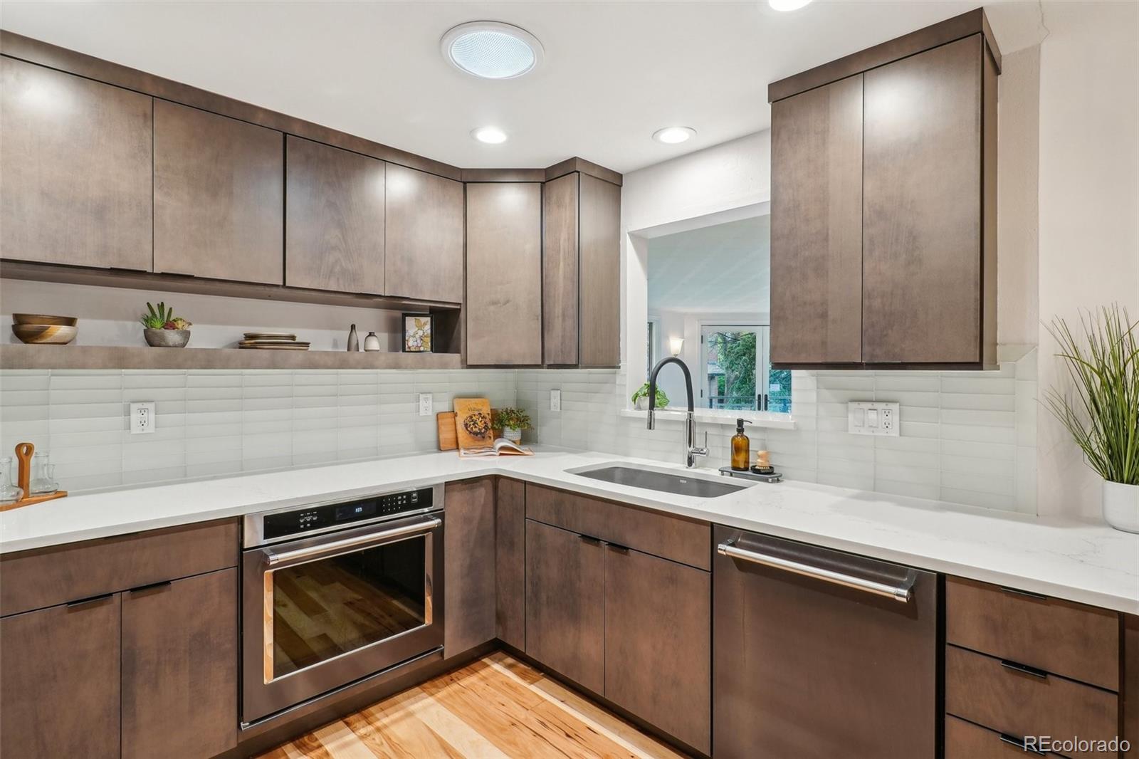 1118 Eagle Road Broomfield, CO 80020 - Photo 12 of 50 a kitchen with a sink cabinets and stainless steel appliances