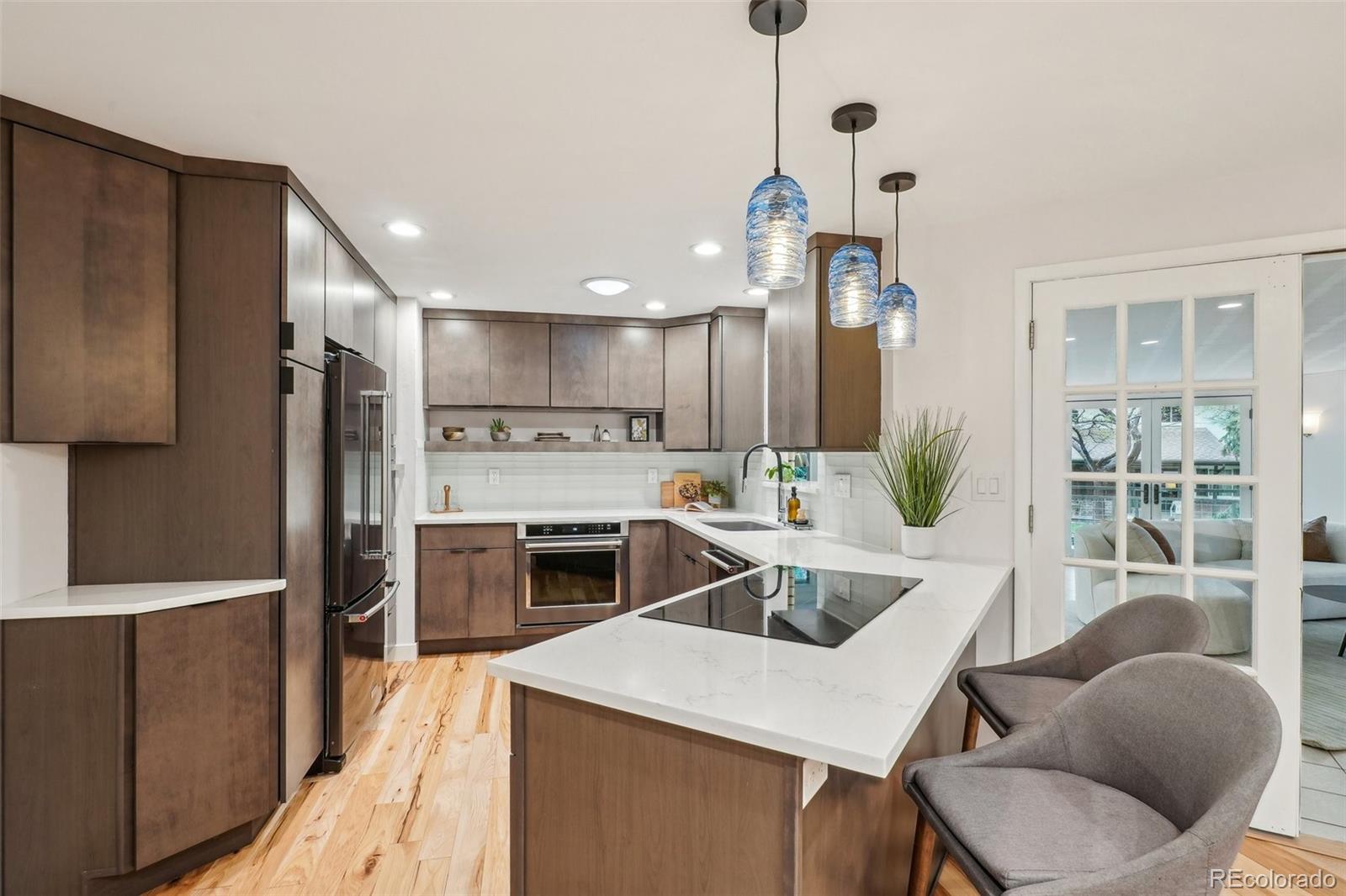 1118 Eagle Road Broomfield, CO 80020 - Photo 13 of 50 a kitchen with white cabinets and stainless steel appliances