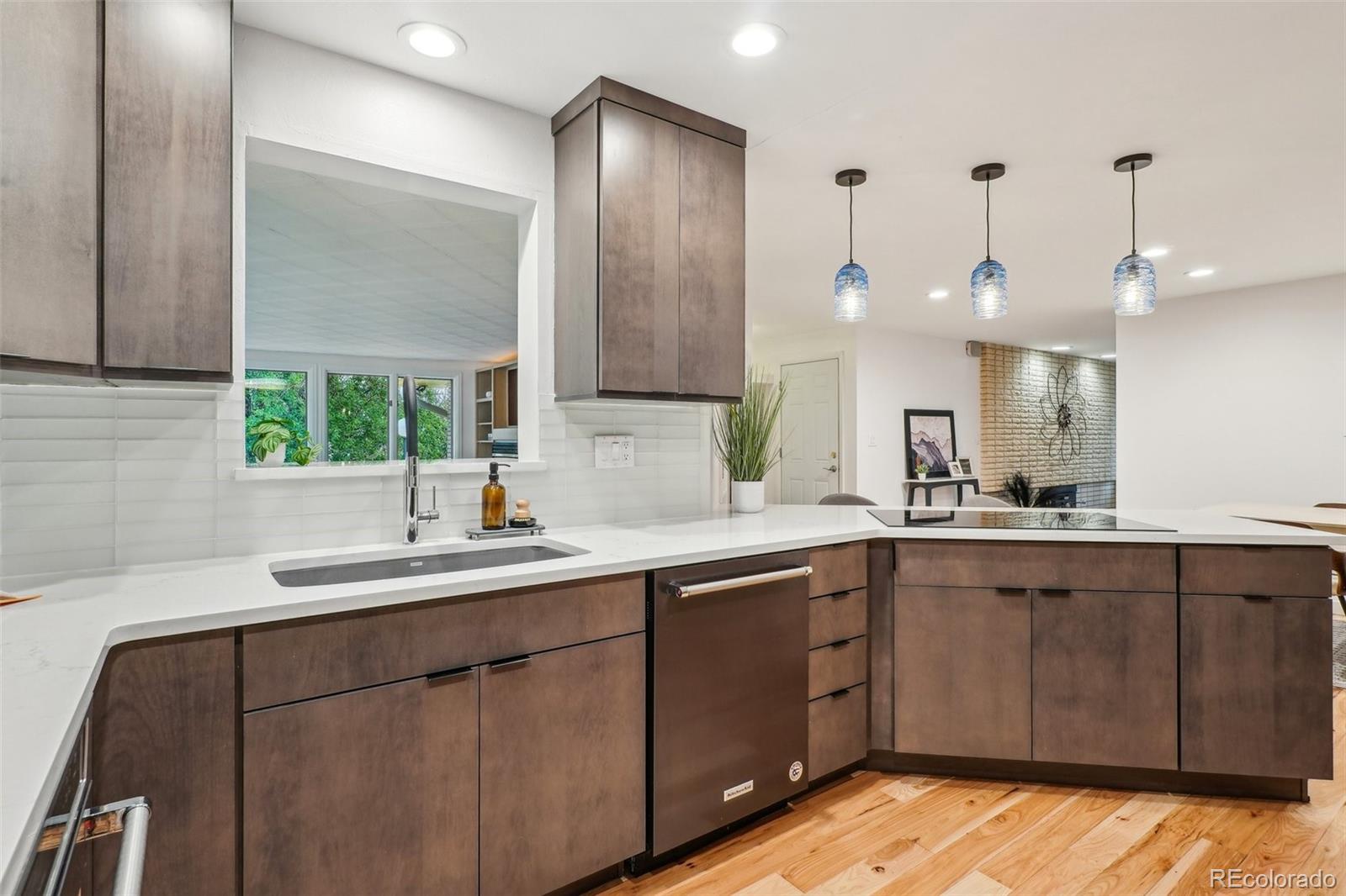 1118 Eagle Road Broomfield, CO 80020 - Photo 14 of 50 a kitchen with a sink cabinets and wooden floor
