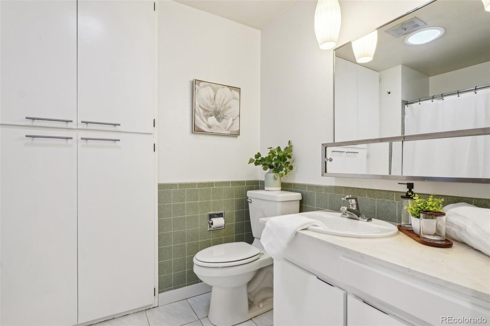 1118 Eagle Road Broomfield, CO 80020 - Photo 28 of 50 a bathroom with a sink a toilet and mirror