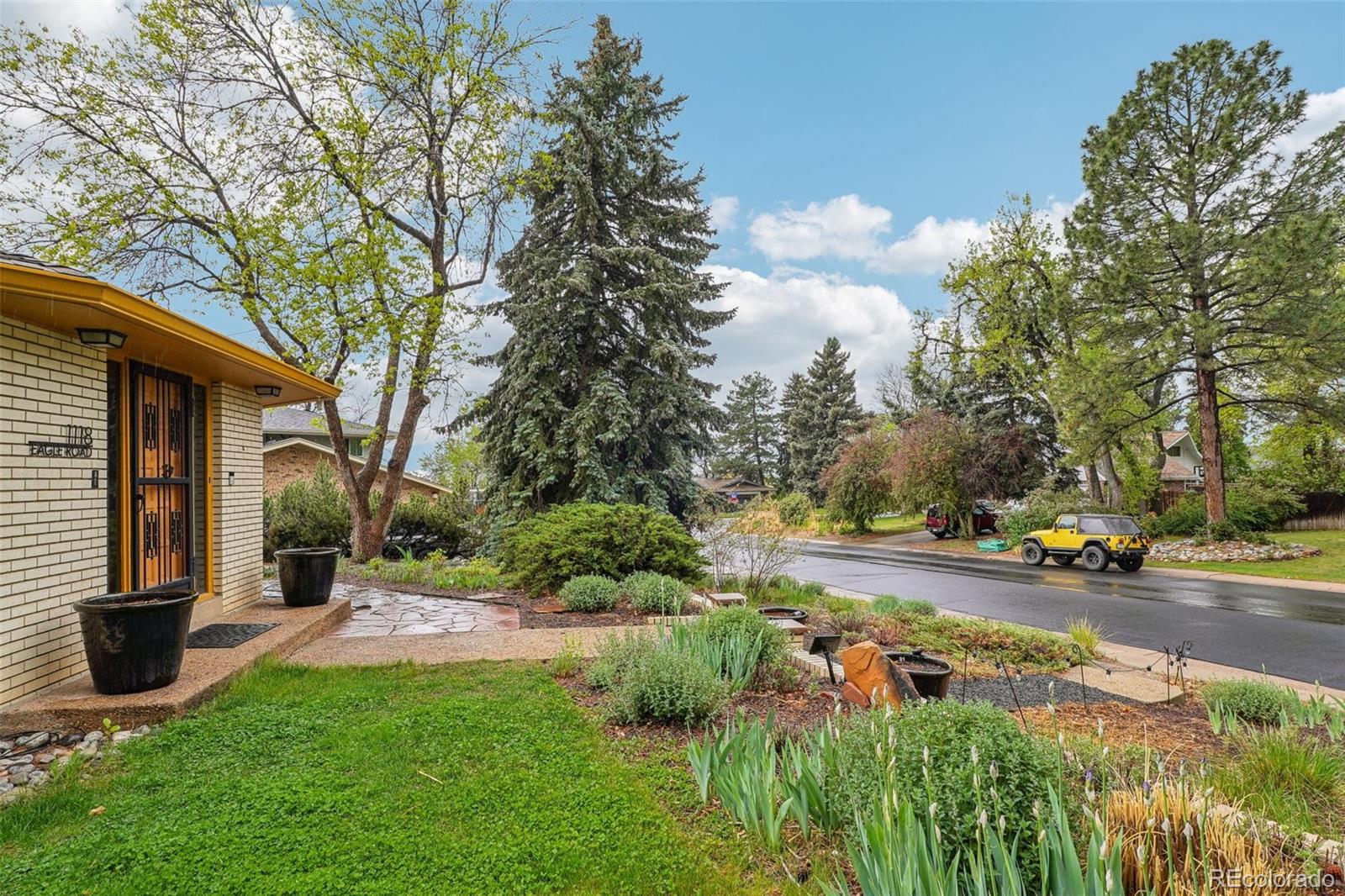 1118 Eagle Road Broomfield, CO 80020 - Photo 42 of 50 a view of a garden with a bench and some trees