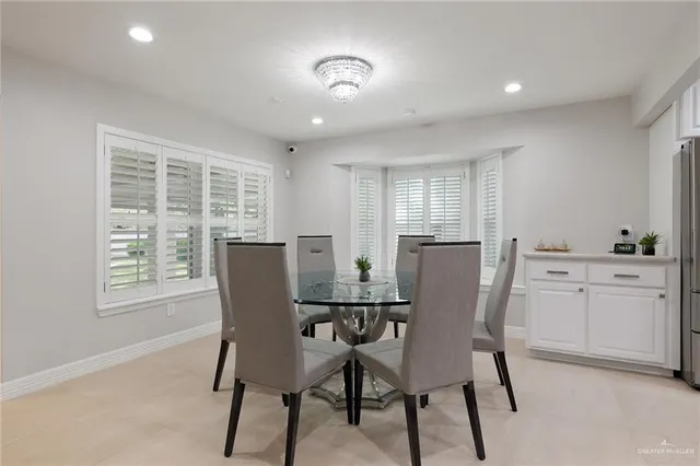 a kitchen with kitchen island white cabinets appliances and sink