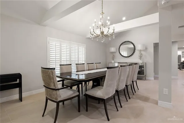 a view of a dining room with furniture a chandelier and wooden floor
