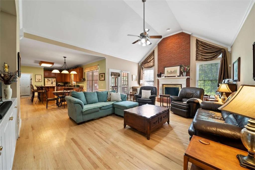 2055 Smyrna Road Southwest Conyers, GA 30094 - Photo 11 of 37 a living room with furniture a fireplace and a flat screen tv