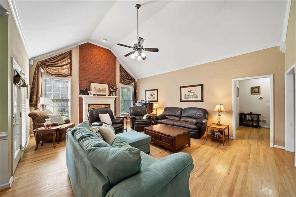 2055 Smyrna Road Southwest Conyers, GA 30094 - Photo 12 of 37 a living room with furniture a fireplace and a chandelier