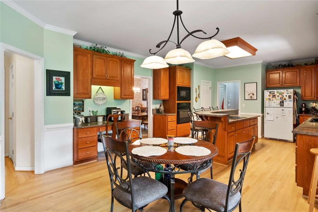 2055 Smyrna Road Southwest Conyers, GA 30094 - Photo 13 of 37 a view of a dining room with furniture window and wooden floor