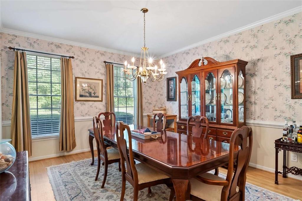 2055 Smyrna Road Southwest Conyers, GA 30094 - Photo 16 of 37 a view of a dining room with furniture window and wooden floor