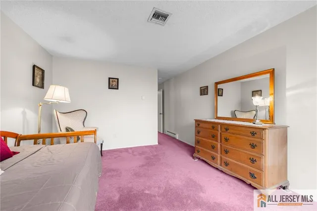 a bed room with a bed and a dresser