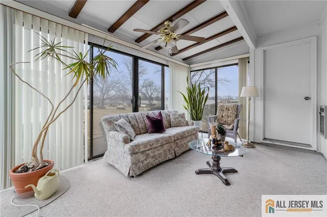 a view of a livingroom with furniture and a potted plant