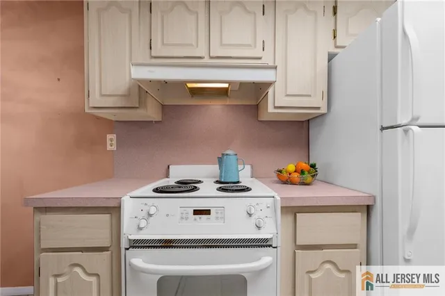 a kitchen with stainless steel appliances granite countertop a stove a microwave and cabinets