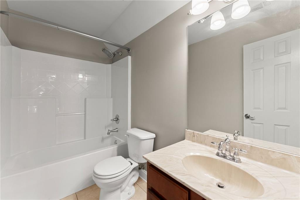 6643 Windvane Point Clermont, GA 30527 - Photo 42 of 88 a bathroom with a sink a toilet and shower