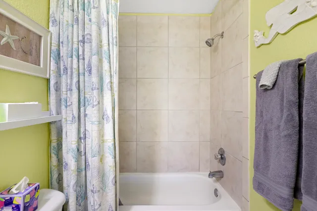 a bathroom with a shower and a bath tub