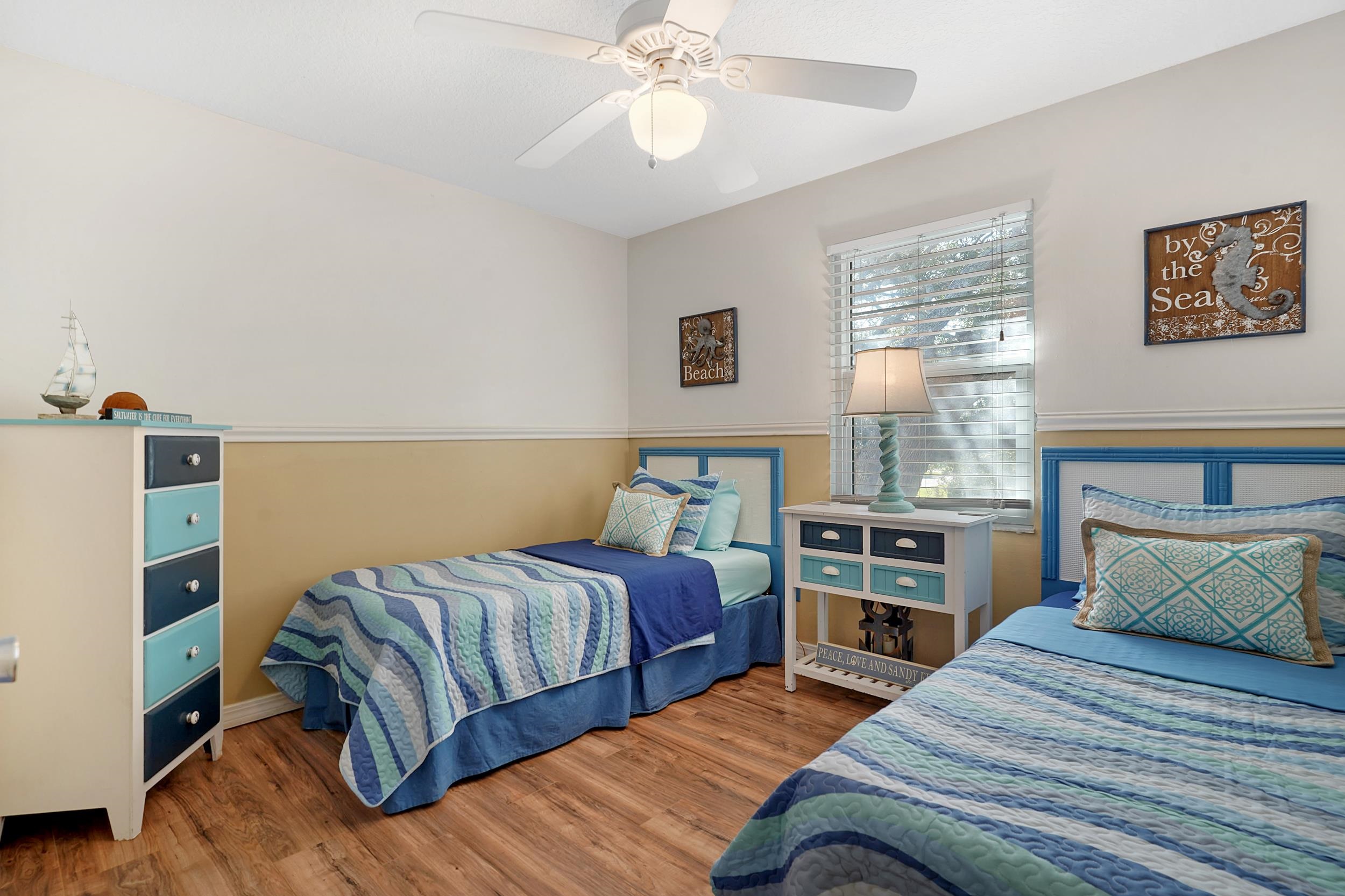 8 Clipper Court St. Augustine Beach, FL 32080 - Photo 17 of 27 a bedroom with a bed and a chandelier