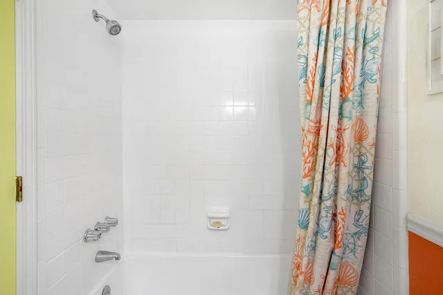 a bathroom with a bathtub and shower