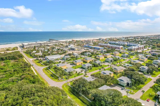 an aerial view of residential houses with outdoor space