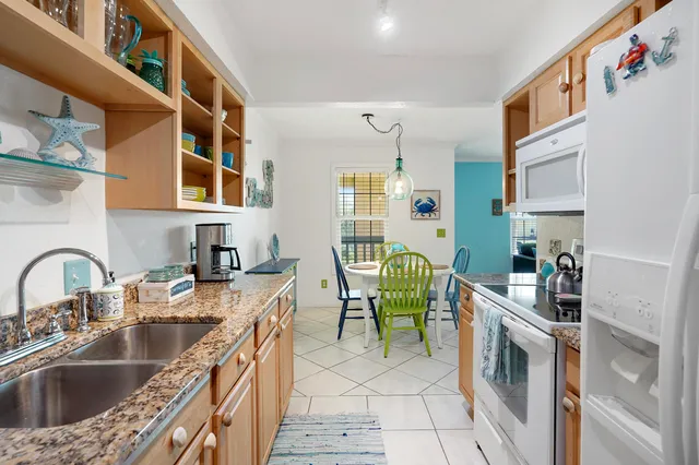 a kitchen with cabinets a sink a stove and a table