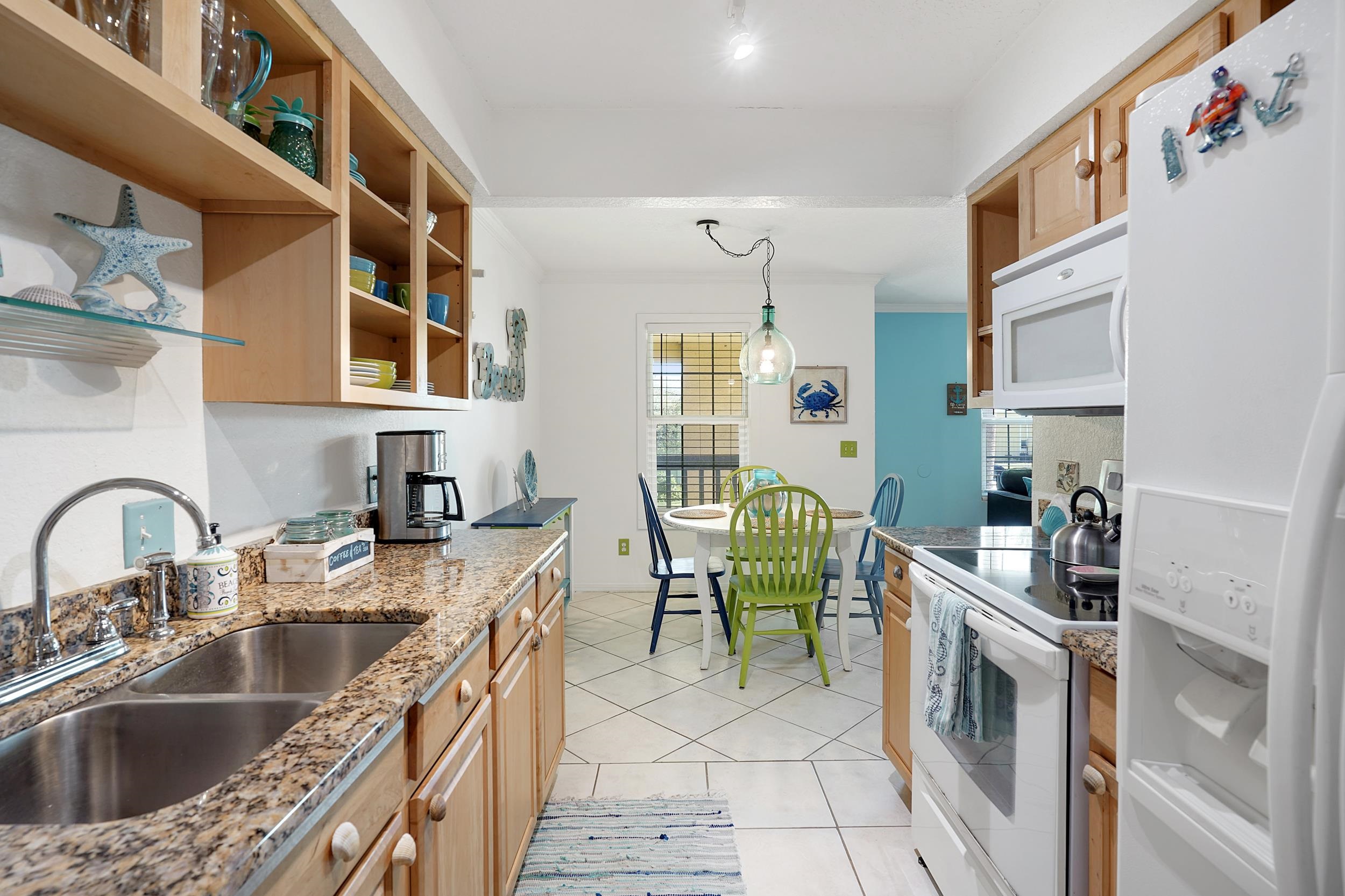 8 Clipper Court St. Augustine Beach, FL 32080 - Photo 8 of 27 a kitchen with cabinets a sink a stove and a table