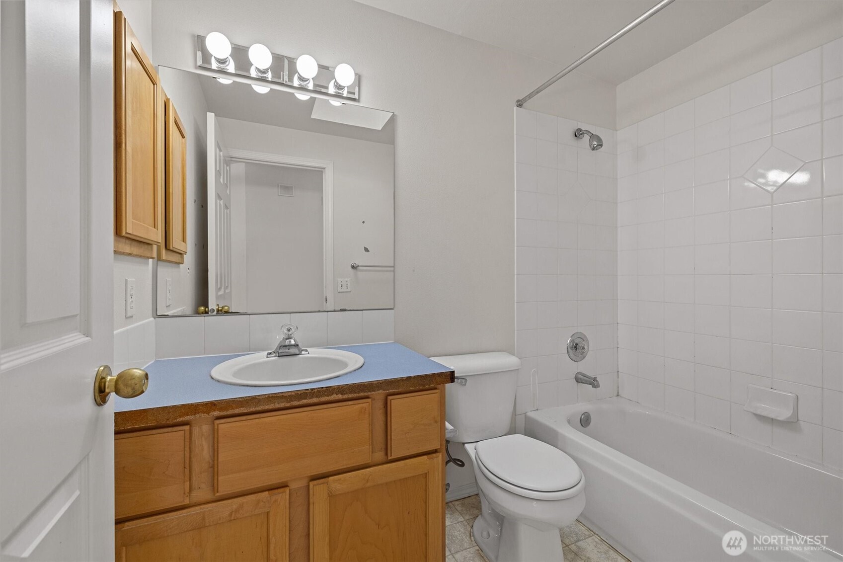 2320 Northeast 102nd Street Seattle, WA 98125 - Photo 13 of 19 a bathroom with a granite countertop sink a toilet and a mirror
