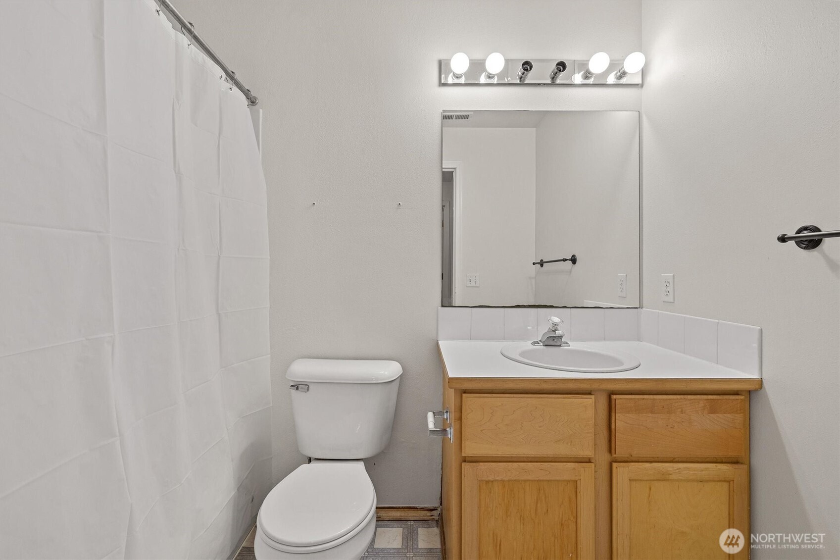 2320 Northeast 102nd Street Seattle, WA 98125 - Photo 16 of 19 a bathroom with a granite countertop sink toilet and mirror