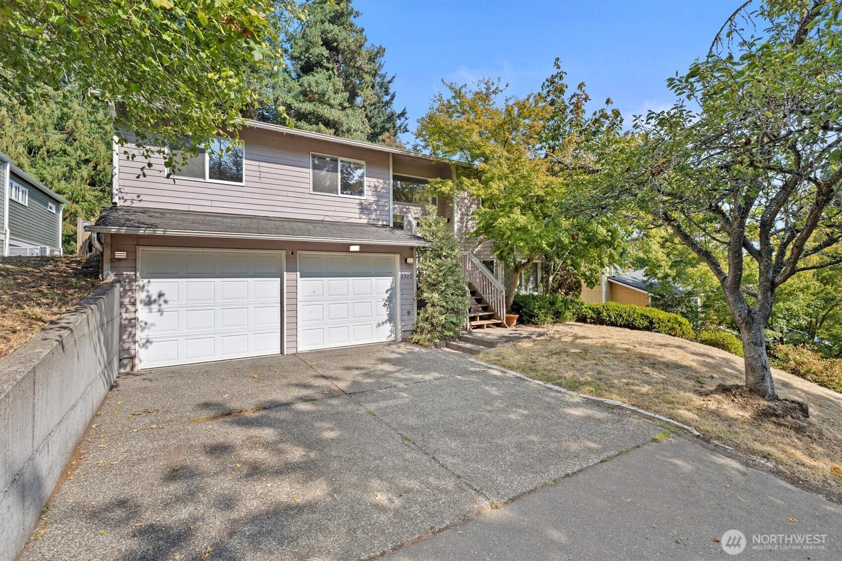 2320 Northeast 102nd Street Seattle, WA 98125 - Photo 18 of 19 a view of a house with a yard and garage