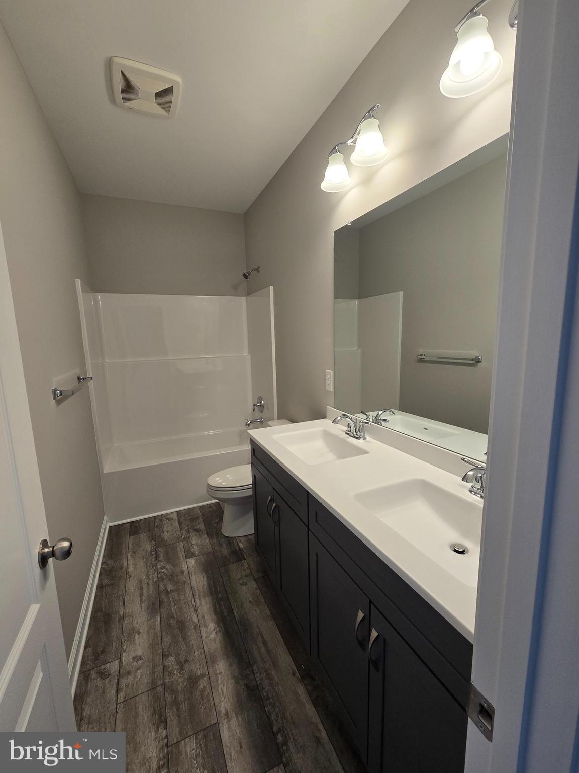 10 Antlered Way Georgetown, DE 19947 - Photo 6 of 29 a bathroom with a sink a toilet a mirror and vanity
