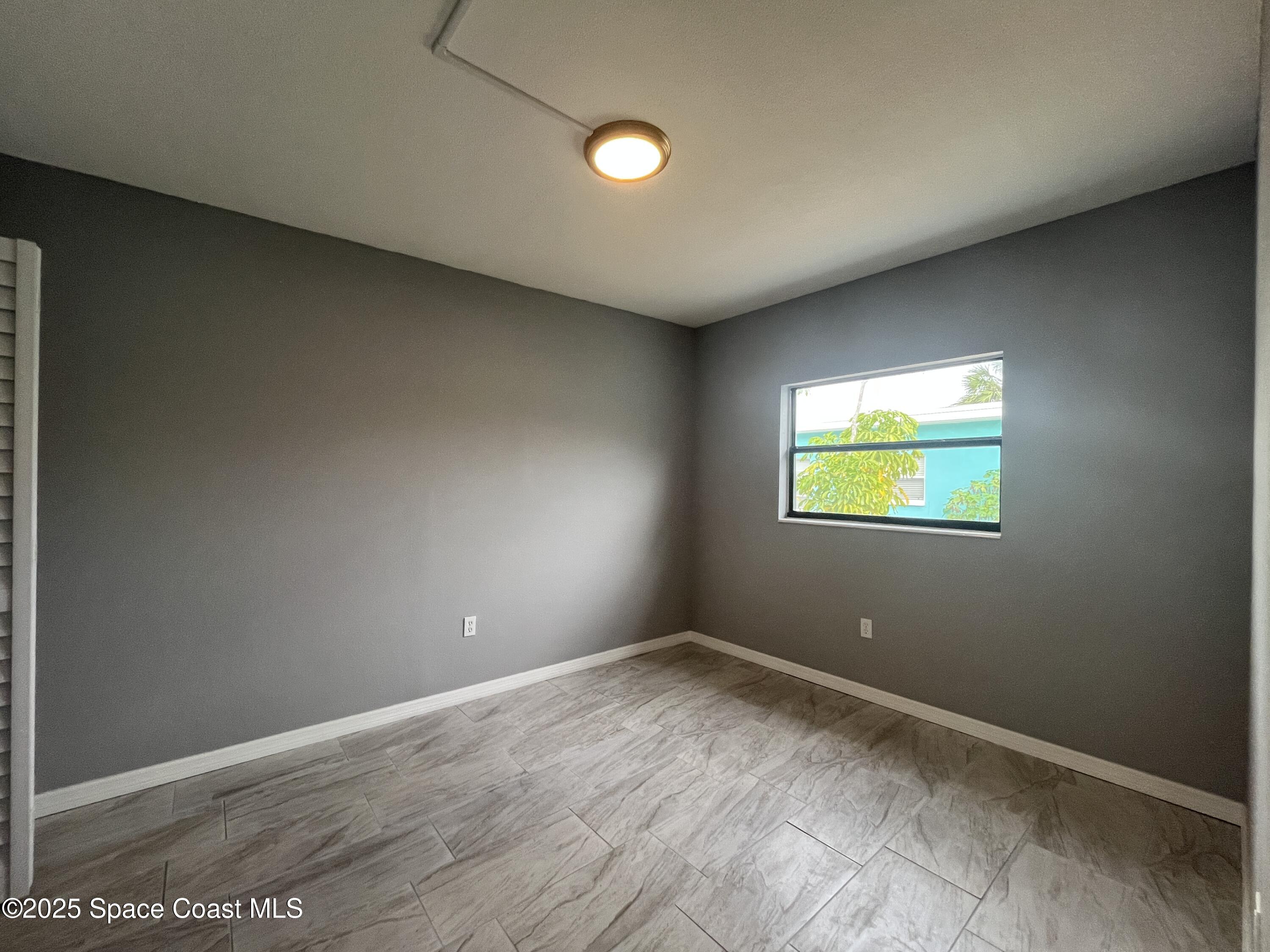 402 Adams Avenue, Unit E Cape Canaveral, FL 32920 - Photo 7 of 8 a view of empty room