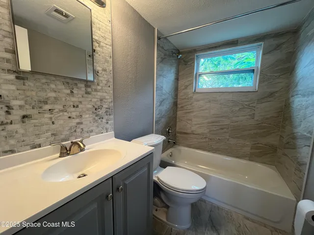 a bathroom with a sink a toilet and bathtub