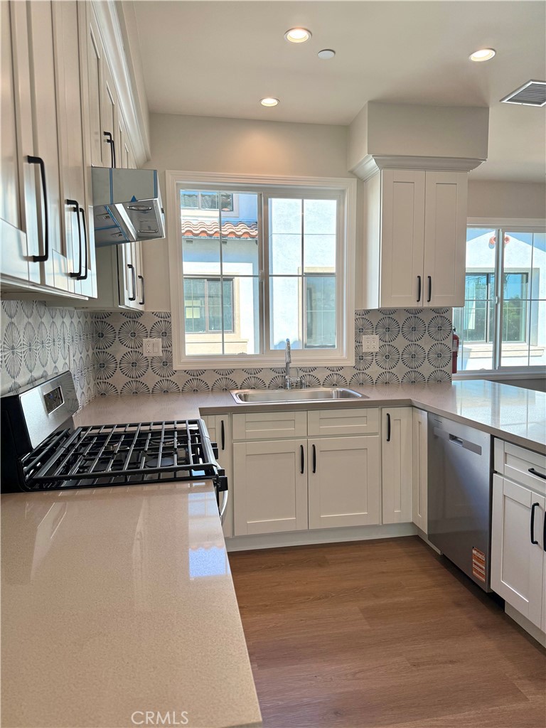 425 West Duarte Road, Unit 411B Monrovia, CA 91016 - Photo 15 of 34 a kitchen with granite countertop a stove a sink and white cabinets