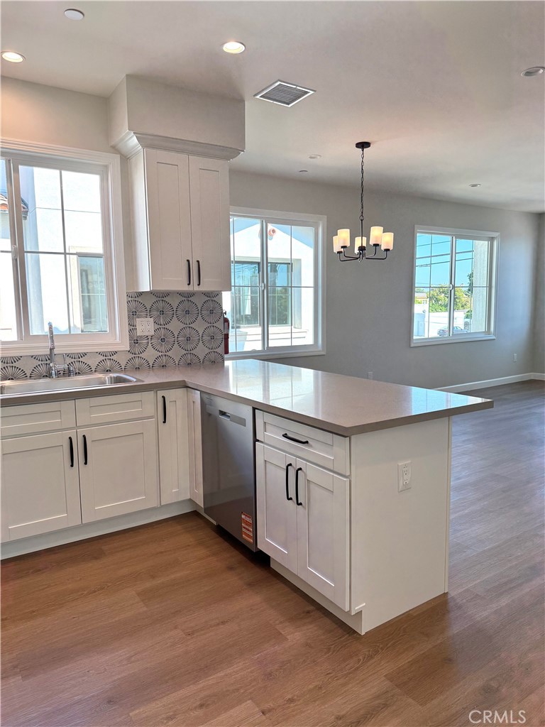 425 West Duarte Road, Unit 411B Monrovia, CA 91016 - Photo 16 of 34 a kitchen with granite countertop white cabinets and white appliances