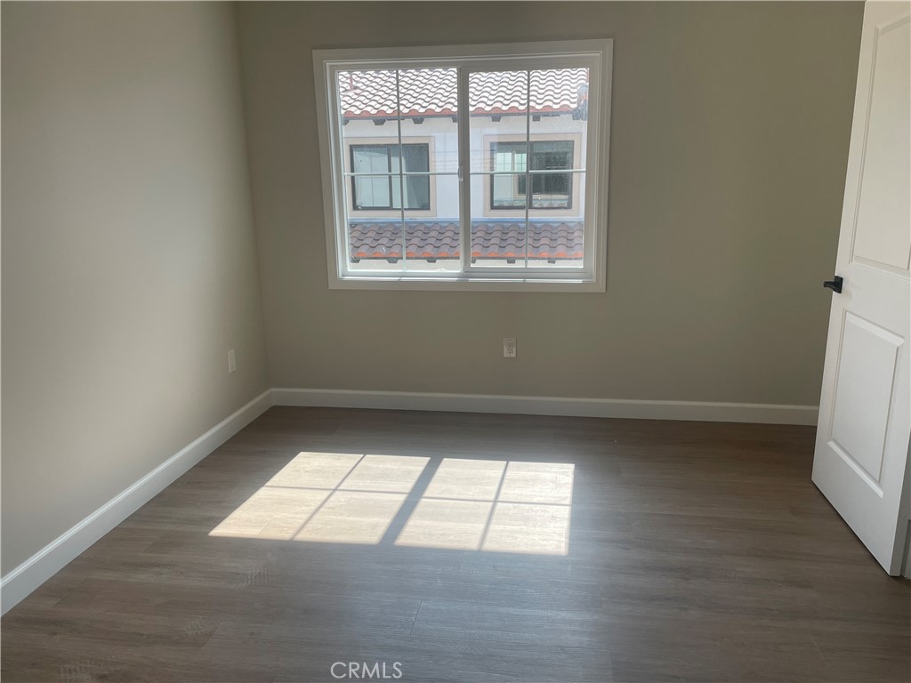 425 West Duarte Road, Unit 411B Monrovia, CA 91016 - Photo 31 of 34 an empty room with wooden floor and windows