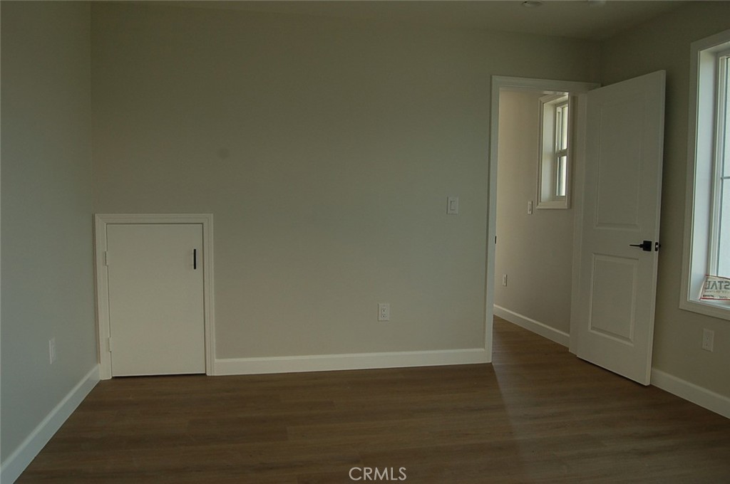 425 West Duarte Road, Unit 411B Monrovia, CA 91016 - Photo 8 of 34 a view of an empty room with wooden floor and a window