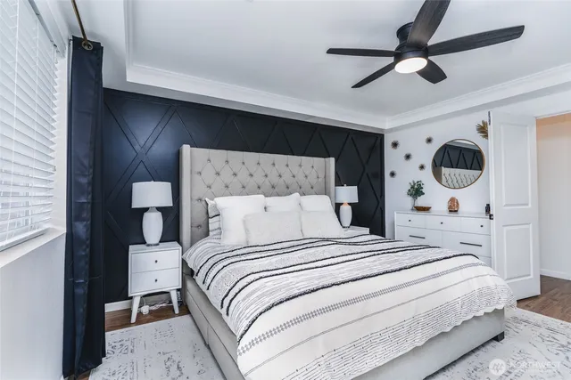 a bedroom with a large bed and a ceiling fan