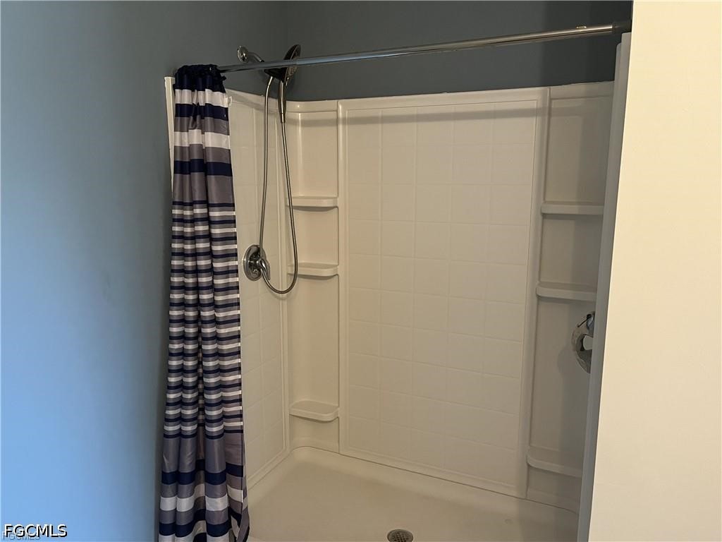 8187 Gopher Tortoise Trail Lehigh Acres, FL 33972 - Photo 16 of 23 a bathroom with a shower