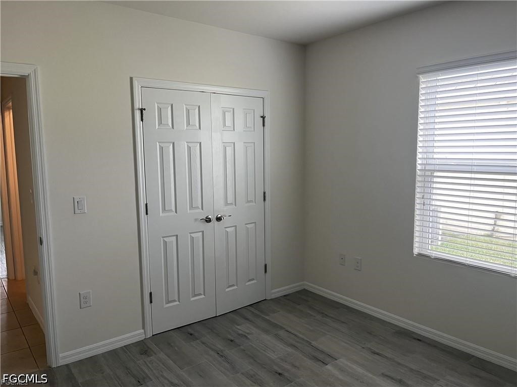 8187 Gopher Tortoise Trail Lehigh Acres, FL 33972 - Photo 22 of 23 an empty room with wooden floor