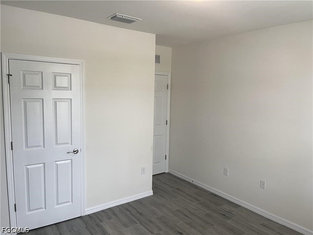 8187 Gopher Tortoise Trail Lehigh Acres, FL 33972 - Photo 7 of 23 wooden floor in an empty room