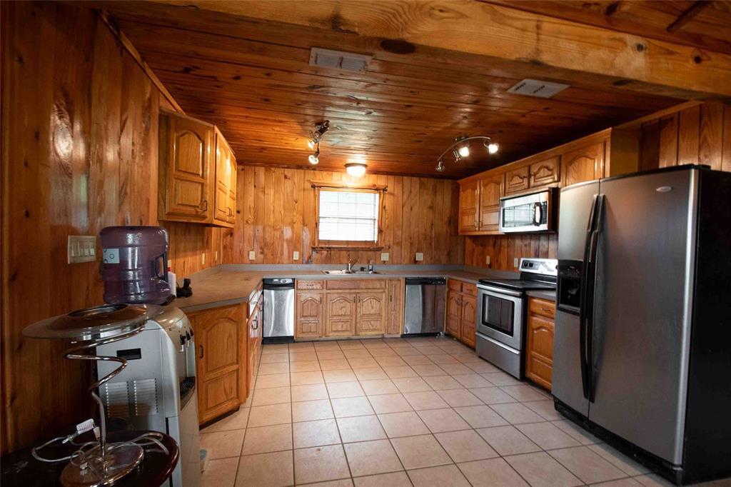 3389 Pvt Road Van, TX 75790 - Photo 4 of 31 a kitchen with stainless steel appliances granite countertop a sink and a refrigerator