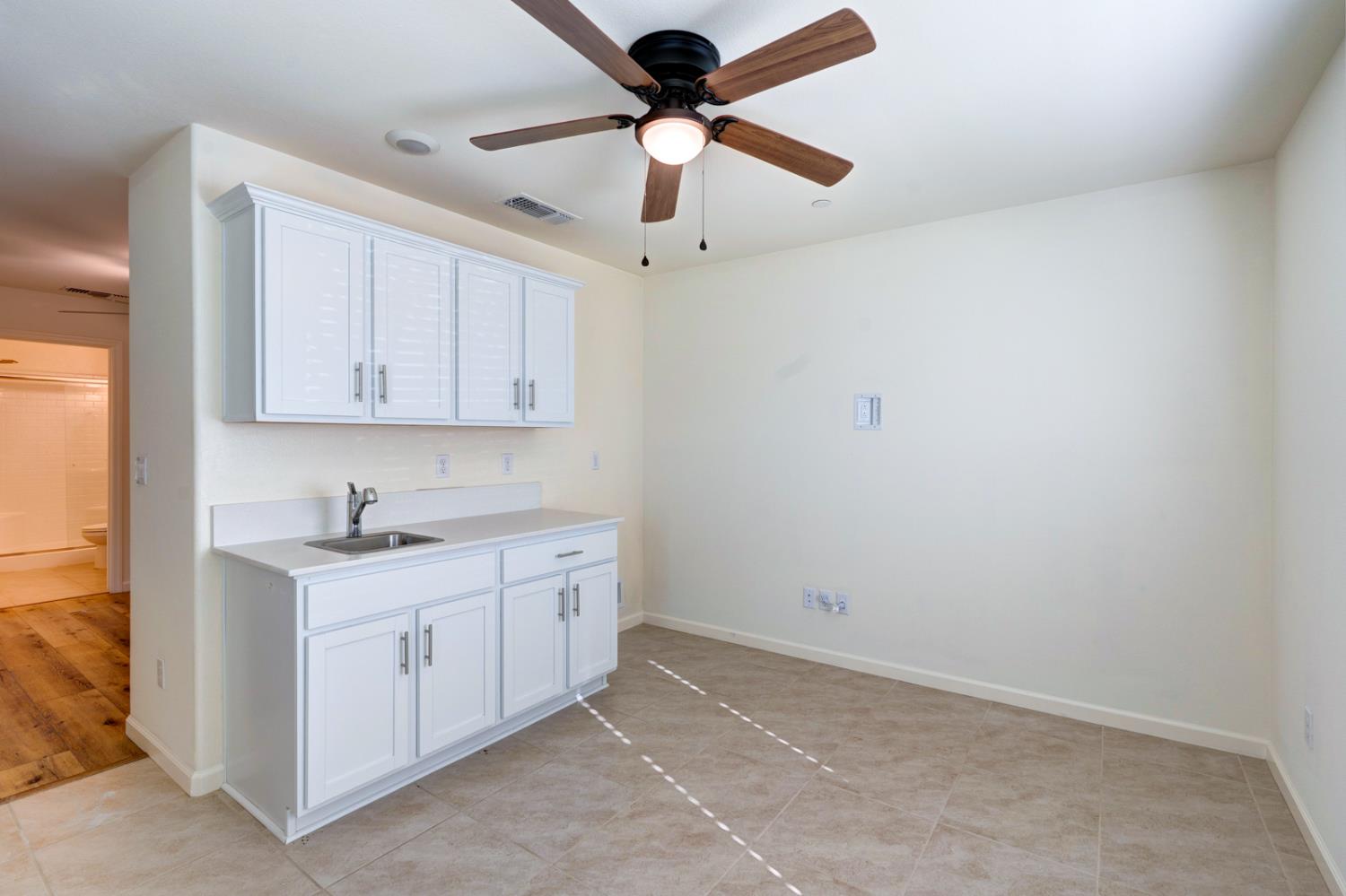 753 Heitz Way Merced, CA 95348 - Photo 15 of 70 a kitchen with a sink cabinets and window