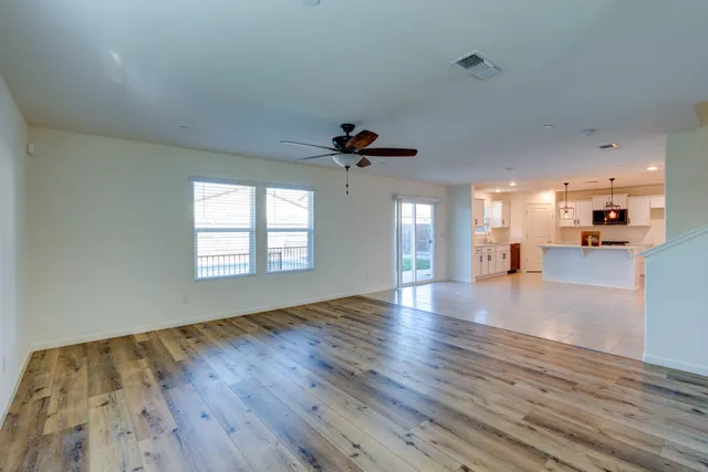 a kitchen with a stove a sink and chandelier