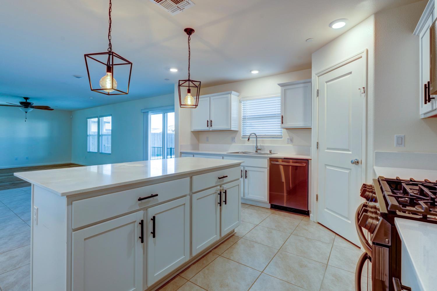 753 Heitz Way Merced, CA 95348 - Photo 26 of 70 a kitchen filled with stainless steel appliances granite countertop a sink a stove and a refrigerator