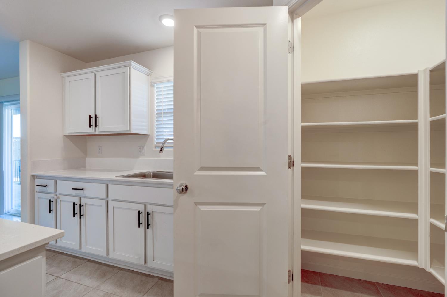 753 Heitz Way Merced, CA 95348 - Photo 28 of 70 a view of cabinets a sink and dishwasher in a kitchen